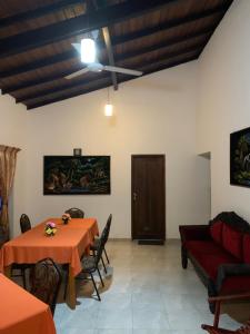 a dining room with a table and chairs at Villa DeLorenta in Anuradhapura