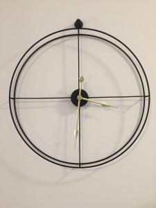 a black and white clock hanging on a wall at Apartamenty Żeglarskie Vęgoria 4 in Węgorzewo