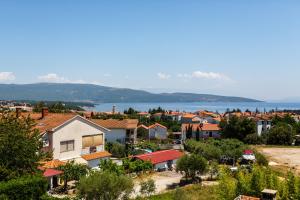 a small town with houses and a lake in the background at Apartments Stupar in Krk