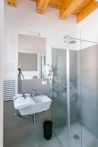 a bathroom with a sink and a glass shower at Boutique BnB Dolcevita in Palermo