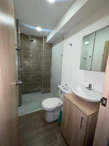 a bathroom with a toilet and a sink and a shower at HOTEL MEDELLIN CENTRAL in Medellín
