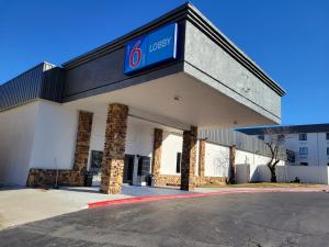 a building with a sign on the front of it at Motel 6 - Bartlesville, OK in Bartlesville