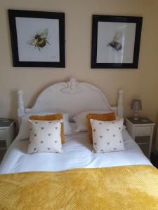 a bed with two pillows and a picture on the wall at Hawthorn House in Blackpool