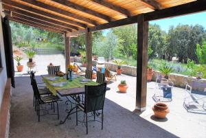 a patio with a table and chairs under a pavilion at VILLA CYCAS relax tra mare e natura in Sperlonga +27 photos