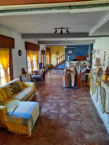 a large living room with couches and chairs in it at Posada de la Villa in Villa Gesell