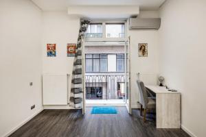 a room with a staircase and a desk and a window at Centre point Apartment in Budapest