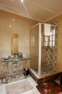 a bathroom with a shower and a sink at Town and Country Mpumalanga in Middelburg