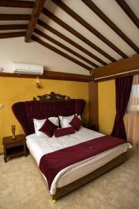 a bedroom with a large bed with a red headboard at Le Chateau Lambousa in Kérynia +33 photos