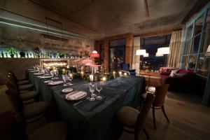 a long table in a room with candles and wine glasses at Ati Ambavi Botique Hotel Gudauri in Gudauri