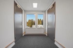 an empty corridor with a window in a building at Uppsala Hotel Apartments in Uppsala