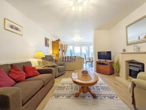 a living room with a couch and a fireplace at Ems Cottage - Emsworth in Emsworth