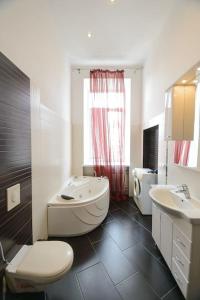 y baño con aseo, bañera y lavamanos. en Comfortable Apartment on Mikhaylovskiy lane, en Kiev