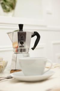 a coffee pot and a cup on a table at A Casa Di Gaia Bed and Breakfast in Vico del Gargano