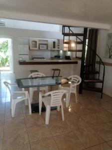a dining room with a glass table and chairs at El Castillo Monte Campana in Puntarenas