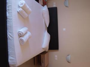 two rolls of toilet paper on top of a bed at Carina Hotel in Rhodes Town