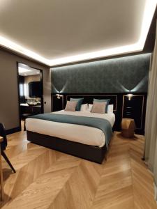 a bedroom with a large bed with a black headboard at IBIZA ROOMs in Logroño