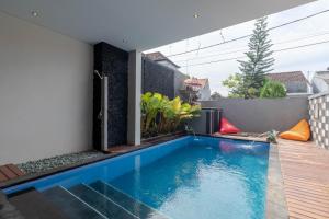 a swimming pool in the backyard of a house at Josh Guest House in Singaraja