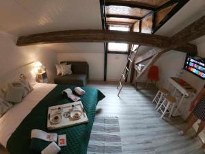 a bedroom with a bed and a tv in a attic at Open Door Loft in Ponta Delgada