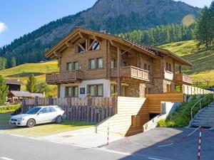 a house with a car parked in front of it at Tilio Chalet in Livigno