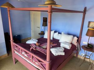 a bedroom with a four poster bed with a canopy at Charming 2 bedroom villa on Fairplay Golf course in Benalup Casas Viejas