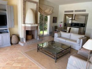 a living room with a coffee table and a fireplace at Charming 2 bedroom villa on Fairplay Golf course in Benalup Casas Viejas