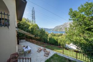 a house with a balcony with a view of the water at Aneta Apartments in Risan