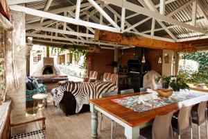 a living room with a table and a zebra at Town and Country Mpumalanga in Middelburg