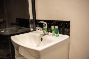 a white sink in a bathroom with a mirror at The Golden Lion Hotel in Middlewich