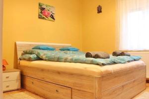 A bed or beds in a room at Relax Wellness Apartman