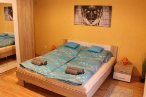 A bed or beds in a room at Relax Wellness Apartman