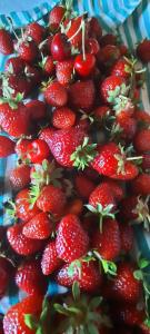 a pile of strawberries sitting on a plate at Cascina Giardini in Alba +76 photos