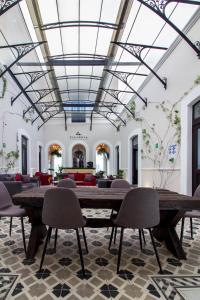 a large room with a large table and chairs at Hotel Business Real 500 in Puebla