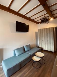 a living room with a blue couch and a table at 11 Luxury Apartments Metsovo. in Metsovo