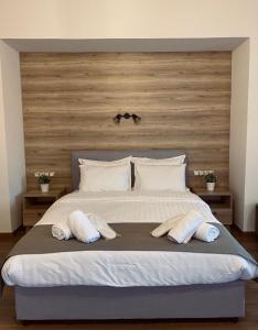 a bedroom with a large bed with two pillows on it at 11 Luxury Apartments in Metsovo