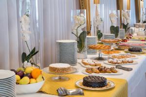 a buffet of food on a table with plates of food at Sant Alphio Garden Hotel & SPA in Giardini Naxos