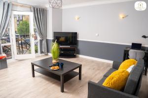 a living room with a couch and a coffee table at The Marina View by Sambridge Stays in Hemel Hempstead