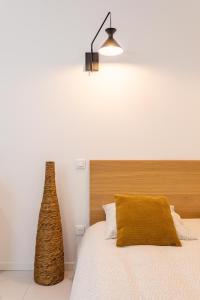 a bedroom with a bed with a wooden headboard and a lamp at Love room Jacuzzi Sauna Privatif Marseille in Marseille