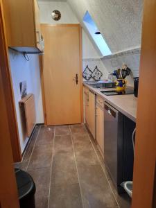 a kitchen with a sink and a door in it at Ferienwohnung Garz in Garz-Rügen