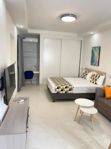 a living room with a bed and a couch at Résidence Cap Sud Ngor Almadies in Dakar