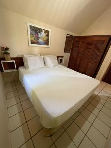 Tempat tidur dalam kamar di Chalé Morro dos Conventos