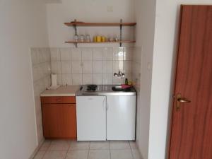 a small kitchen with a sink and a stove at Apartments Vili Betina in Betina +51 photos