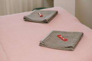 Postel nebo postele na pokoji v ubytování Lusso Apartman