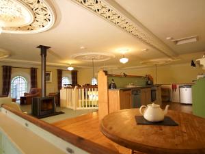 a kitchen and living room with a table with a vase on it at Pass the Keys Beautiful Historic Chapel Conversion in Machynlleth