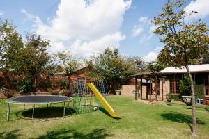 a playground with a slide and a trampoline at Town and Country Mpumalanga in Middelburg