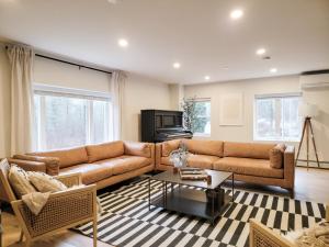 a living room with a couch and a coffee table at Hideaway Lodge - Glen Lake, Lake George in Lake George