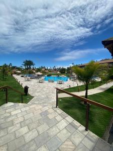 a resort with a swimming pool and a fence at FLAT PRAIA DOS CARNEIROS - Eco Resort Praia dos Carneiros ao lado da Igrejinha in Rio Formoso