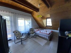 a bedroom with a bed and a table and chairs at Edelmann Panzió in Balatonakali