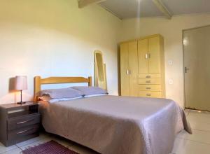 a bedroom with a bed and a dresser with a lamp at sitio santa Eulalia in Cunha +25 photos