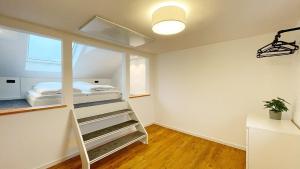 a bedroom with a stairway leading to a bed at Uraha Apartments Fürth in Fürth