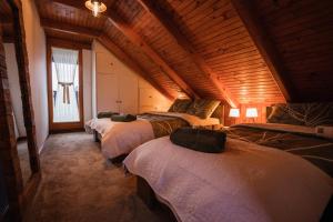 a group of four beds in a room at Holiday Home Hygge Nova in Grabrovnik